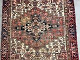 an old persian rug on the floor in a room