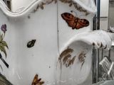 a large white bowl with a butterfly design on it