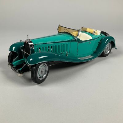 a model of a green car on a white surface