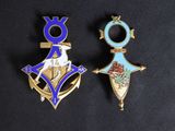 two pins with a blue and gold design on them