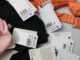 a pile of clothes and clothing tags on a table