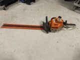 a chainsaw sitting on the floor in a garage