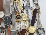 a lot of watches that are sitting on a table