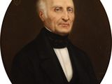 portrait of a man in a black suit and bow tie