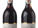 two bottles of wine sitting next to each other on top of a table
