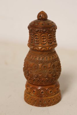 a small brown vase that is sitting on a table