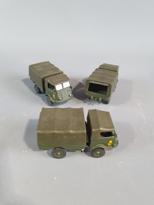 four toy army vehicles that are sitting on a table
