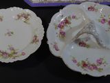 two plates and a bowl sitting on a table