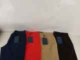 a group of men ' s pants sitting on top of a white table