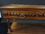 an old wooden table with a drawer on top of it