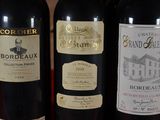 three bottles of wine are lined up on a table