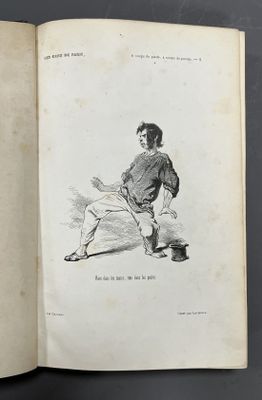 an open book with a drawing of a man holding a baseball bat
