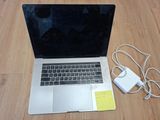 a laptop computer sitting on a wooden floor with a charger