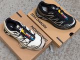 pair of black and white shoes sitting on top of a cardboard box