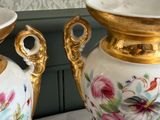 two vases that are sitting on a table