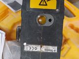 a close up of a yellow and black device in a trash can