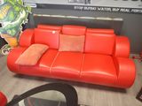 an image of a red leather couch in a living room