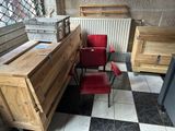 a red chair sitting in front of a wooden desk
