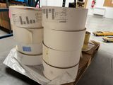 three rolls of tape on a pallet in a warehouse