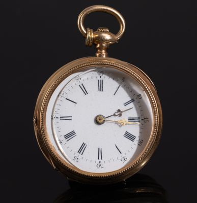 a gold pocket watch with roman numerals on the face