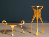 two chairs and a table in a room with a blue wall