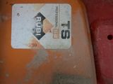 a close up of a gas can on the ground