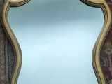 a mirror hanging on the wall next to a rug