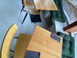 tables and chairs in a restaurant with a view of the outside