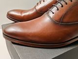 a close up of a pair of shoes on top of a box