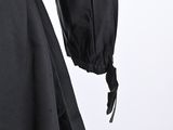the back view of a black jacket with a hood on it
