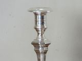 a silver candle that is sitting on a table