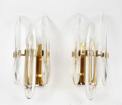 pair of sconces in the shape of glass and brass