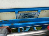 a close up of a blue bench with a sign on it