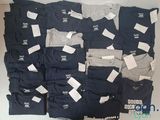 a lot of men ' s t - shirts that are on display