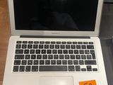 a laptop computer sitting on a table with a price tag on it