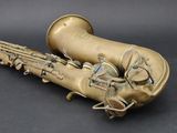 a saxophone that is sitting on a black surface