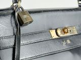 the handle of a black purse with a padlock on it