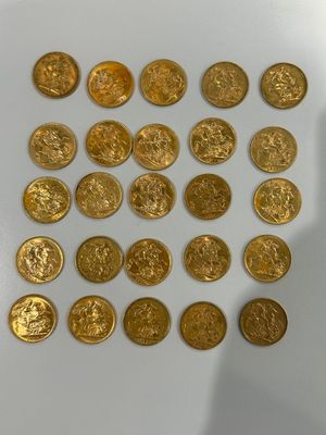 a close up of a pile of gold coins on a white surface