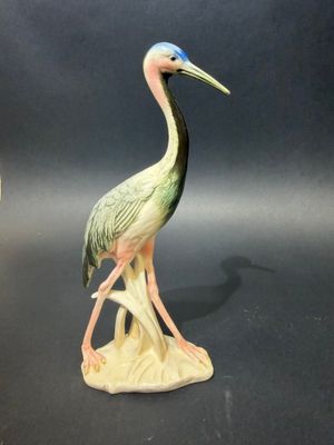 a bird that is standing on a tree stump