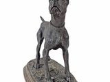statue of a dog on a wooden base on a white background
