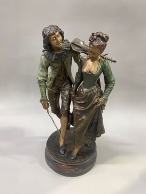 statue of a man and a woman with a violin on a base