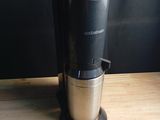 a coffee maker sitting on a wooden table