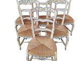 six chairs with blue and white designs are lined up against a white background
