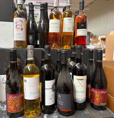 de nombreuses bouteilles de vin posées sur une table dans une pièce