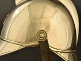 a close up of a silver helmet on a black background