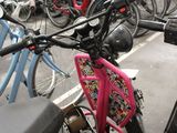 many bikes parked in a parking lot next to each other