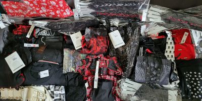 many bags of clothes and bags of clothing on the floor