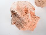 two pieces of wood that have been carved into the shape of a human head
