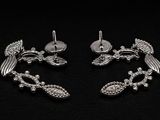 paire de boucles d'oreilles en forme d'oiseaux plaquées argent, ornées de cristaux sur fond noir
