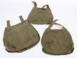 three bags are lined up on a white surface with a white background